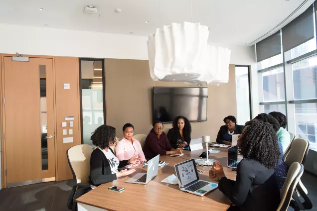 A group of people having a meeting in a conference room