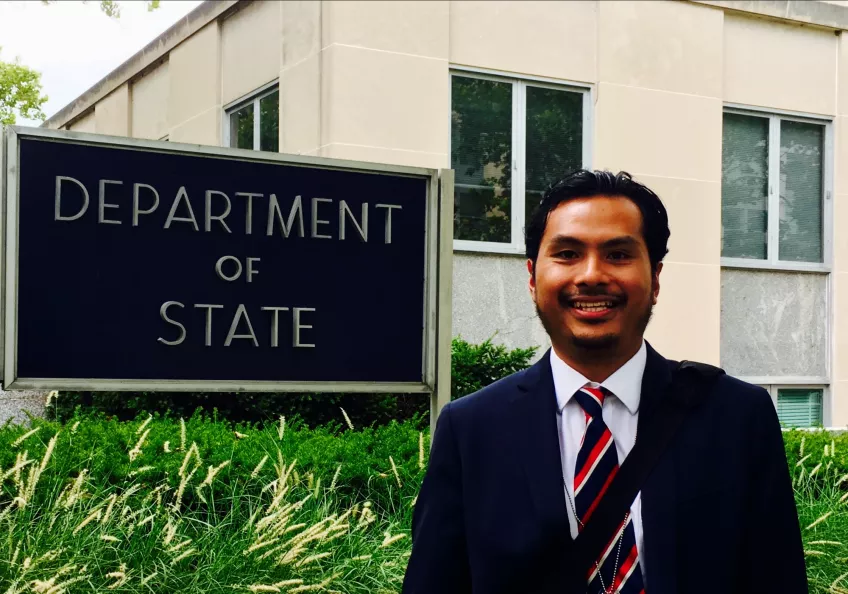 Alumnus Agga in front of Department of State Headquarters